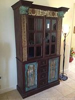 Full view of the Arhaus Relic Hutch showing the top and bottom sections with glass doors and wooden lower doors.