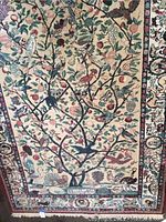 Close-up detail of the tree of life design showing various colorful birds and fruits on branches with border pattern visible.