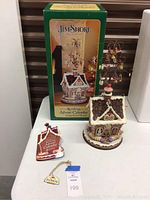 Front view showing box, cottage figurine, instruction booklet and hang tags