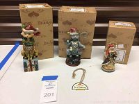 Three Jim Shore cat figurines displayed with their original boxes and a Jim Shore tag, showing the complete lot.