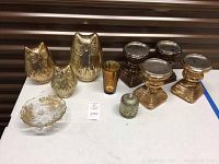 Full set of illuminated owl figurines, candle stands, decorative glass bowl and jar displayed together on table