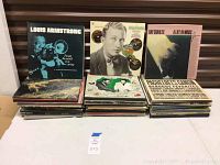 Six albums in front row including Louis Armstrong ‘I’ve Got the World on a String’, Bing Crosby portrait LP and Ray Charles ‘A Life in Music’.