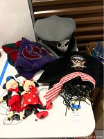 Mickey and Minnie marionette puppets with costume hats displayed on table, strings partly unattached