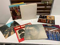 Seven album covers arranged on table