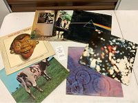 Photo showing six Pink Floyd vinyl albums including Atom Heart Mother and Dark Side of the Moon with their iconic cover art.
