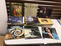 Photo showing a variety of vintage vinyl records arranged on a table including Styx, Frank Sinatra, The Moody Blues, James Taylor, and others.