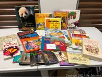 Table spread showing multiple children's books including Giant Pandas, The Nutcracker, Beatrix Potter, ABC Dinosaurs.