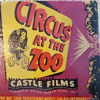 Close-up of the original colorful box for the movie reel titled Circus At The Zoo by Castle Films with cartoon monkey on bicycle graphic.
