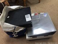 Black binder and plastic storage box on carpet