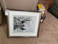 Framed print of a loon in water showing subject and overall appearance of the artwork with the frame included.
