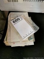 Stack of assorted stamps mostly in glassine envelopes with MaxSold identification tag