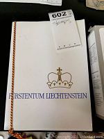 Front cover of the stamp collection book titled 'Furstentum Liechtenstein' with a golden crown emblem.
