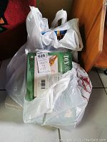 Four plastic bags containing assorted scrapbook rubber stamps, one showing a labeled box with number 628