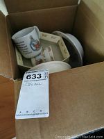 Box containing Bunnykins china including a mug and a bowl with vintage character designs.