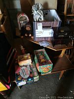 Overview shot showing tin piano music box, jukebox model, boxed toys, tin duck and plush gorilla.