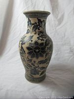 Front view of the blue-painted oriental vase showing floral patterns and geometric border.