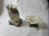 Both carved hardstone pieces displayed together on white background
