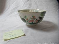 Porcelain bowl viewed from side showing hand-painted flowers and birds along with a note indicating 'Qing Late 1800's'.