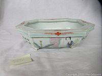 Top side angled view of rectangular porcelain jardiniere showing hand-painted figures and floral motifs