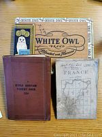 Pocket book, map cover, and background box showing overall lot contents