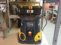 Front view of Mastercraft oscillating spindle sander showing power switch, cord, accessory holders with sanding discs