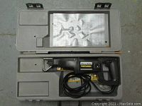 Black & Decker Professional reciprocating saw in gray molded plastic carry case with instruction sheet under lid.