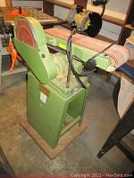 Front quarter view of green painted Busy Bee belt and disc sander on stand