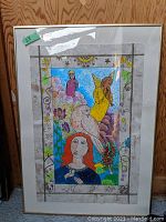 Framed front view of the signed acrylic painting depicting a woman with orange hair, dove and angels