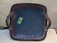 Top view of square ceramic slab platter with handles, blue and garnet glaze