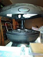 Aerogrow AeroGarden black indoor hydroponics system with five pod deck and integrated grow lights on top.