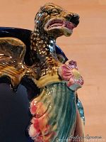 Close-up of one dragon head handle showing polychrome enamel detail.