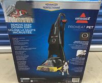 Box featuring Bissell ProHeat Pet carpet cleaner product with features listed and image of unit.