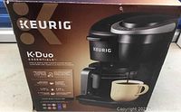 Box showing Keurig K-Duo Essentials branding and images with product features, 1.77 L capacity listed