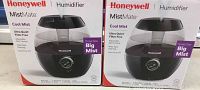Two Honeywell MistMate Cool Mist humidifiers in original boxes, showing packaging and product image