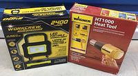 Boxed Workcrew LED portable work light and boxed Wagner HT1000 heat tool together showing packaging and brand names