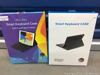 Two iPad keyboard cases in open box packaging, one with colorful box and one plain white box showing product images and text.