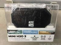 Mini H2O 3 rugged Bluetooth speaker in clear waterproof case showing front and brand name.