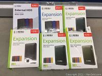 Photo showing all six KESU external hard drive boxes arranged together: three 320GB units, one 250GB, one 160GB, one 120GB.