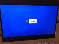 Photo of the portable monitor powered on showing 'No Signal' message, confirming the screen functions.