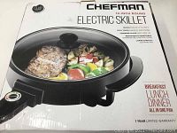 Box showing Chefman 12-inch round electric skillet with image of skillet cooked food and product features.