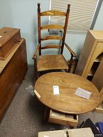 Overall view of chair and oval wooden table showing condition and arrangement.