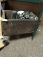 Wooden crate containing 15 glass bottles showing condition and arrangement inside the crate.