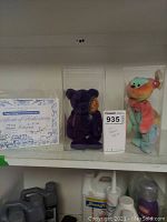 Overall shot showing two Beanie Babies in cases and Certificate of Authenticity