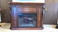 Front view of electric fireplace showing wood surround and insert