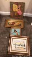 All four paintings laid out on carpet, showing varying sizes and frames.