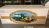 Front of box showing green and yellow tanker truck illustration