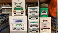 Stacked boxes of Hess trucks illustrating different years including 1995, 1988, 2004, 1989 series in original sealed boxes