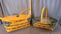Two woven Longaberger baskets side by side showing lid and handles with green plaid liners.