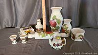 Full view of assorted Portmeirion ceramic lot including rolling pin, two vases, two egg cups, teapot, butter dish, and small bowl, showing fruit and leaf designs