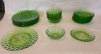 Six 8-inch small plates, ten 5.5-inch plates, and six 4.5-inch small bowls arranged on white background showing overall set composition and green translucent look.